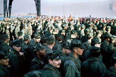 Men of the 32nd Marine Amphibious Unit stand in a mass formation on the dock, after departing the amphibious assault ship USS GUAM (LPH-9). The Marines are returning from Beirut, Lebanon