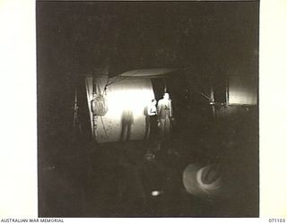 KILIGIA, NEW GUINEA, 1944-03-14. 3RD ARMOURED DIVISION CONCERT PARTY PERFORMING UNDER JEEP HEADLAMPS ON AN IMPROVISED STAGE ERECTED BY MEMBERS OF THE 5TH AUSTRALIAN DIVISION. THE SMALL ..