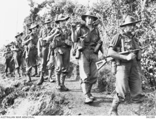 SHAGGY RIDGE, NEW GUINEA. 1943-12-27. PERSONNEL OF D COMPANY 2/16TH AUSTRALIAN INFANTRY BATTALION, 21ST AUSTRALIAN INFANTRY BRIGADE MOVING ALONG A TRACK ON THEIR WAY TO THE FRONT LINE DURING THE ..