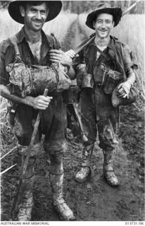 Two members of the 2/33rd Battalion coming out for a spell from their own position which was then just one hundred yards from the Japanese positions. Identified is NX44907 Sergeant Stanley Pretty, ..