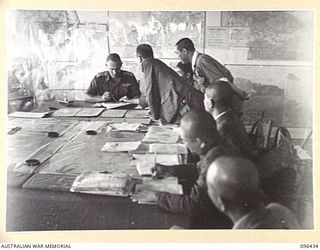 CAPE WOM, NEW GUINEA, 1945-09-13. AT A CONFERENCE BETWEEN STAFF OFFICERS OF 6 DIVISION, HEADED BY LIEUTENANT-COLONEL J. BISHOP GENERAL STAFF OFFICER I, AND JAPANESE STAFF OFFICERS OF 18 JAPANESE ..