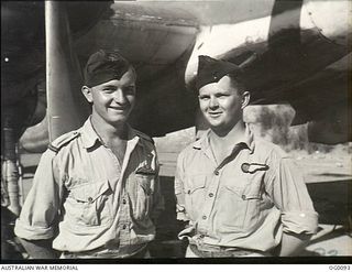 PORT MORESBY, PAPUA. C. 1943-07. FLYING OFFICER KEITH NICHOLSON, NORTHAM, WA (LEFT) AND HIS OBSERVER FLYING SERGEANT KEN DELBRIDGE, ASHGROVE, QLD, OF NO. 30 (BEAUFIGHTER) SQUADRON RAAF AFTER THEY ..