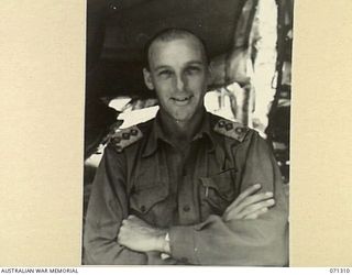 RAMU VALLEY, NEW GUINEA, 1944-03-21. QX2764 CAPTAIN D.N. CHILDS (1), OFFICER COMMANDING 7TH DIVISION POSTAL UNIT, AT HEADQUARTERS, 7TH DIVISION