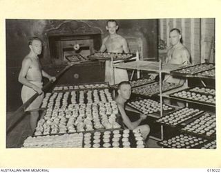 1943-06-15. NEW GUINEA. A.I.F. BAKERS AT WORK IN NEW GUINEA. SIX HUNDRED DOZEN MIXED CAKES ARE COOKED EACH DAY FOR CANTEEN SERVICES. PTE. N.J.C. CLARK, OF WALKERVILLE, SOUTH AUSTRALIA, PTE. T.R. ..