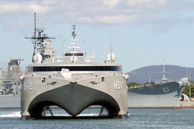 Bow on view of the US Navy (USN) experimental High Speed Vehicle 2 (HSV 2) Swift as it maneuvers around Ford Island near the battleship Missouri (BB 63) while shifting berths at Pearl Harbor, Hawaii (HI). Swift is taking part in the multi-national maritime Exercise RIM OF THE PACIFIC 2004 (RIMPAC). RIMPAC is the largest international maritime exercise in the waters around the Hawaiian Islands. This yearßs exercise includes seven participating nations: Australia, Canada, Chile, Japan, South Korea, United Kingdom and United States. RIMPAC is intended to enhance the tactical proficiency of participating units in a wide array of combined operations at sea, while enhancing stability in the...