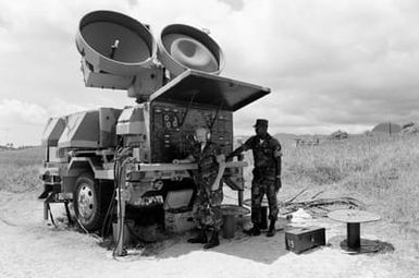 GUNNERY Sergeant (GYSGT) H. Gray and GYSGT L. Reid of Marine Air Control Squadron Two operate a Hawk surface-to-air missile high power illuminator/tracker radar during Operation KERNAL BLITZ