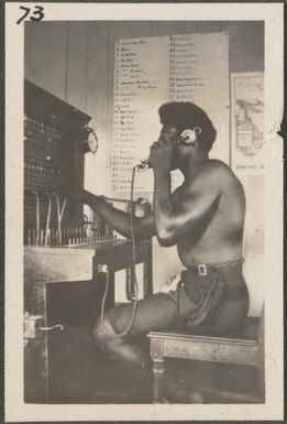 Papuan man at telephone switchboard at Rabaul Post Office, New Britain Island, Papua New Guinea, approximately 1916