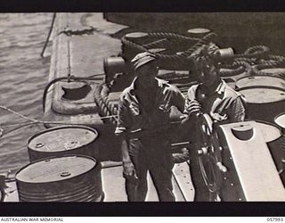 LAE, NEW GUINEA. 1943-10-12. TWO AUSTRALIAN SEAMEN APPRENTICES EMPLOYED ON THE PD.240, THE 50 TON FLOATING CRANE, OPERATED BY THE UNITED STATES SMALL SHIPS SECTION. THEY ARE:- JOSEPH CONLEY (LEFT) ..