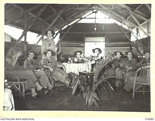 BOUGAINVILLE ISLAND. 1945-01-23. NFX76276 MATRON M.E. HURLEY (2) AND SOME OF THE SISTERS OF THE 2/1ST AUSTRALIAN GENERAL HOSPITAL RELAX IN THEIR MESS