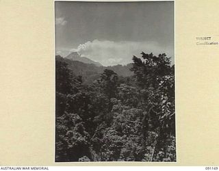 NUMA NUMA TRAIL, BOUGAINVILLE. 1945-04-23. MT. BAGANA, COMMONLY KNOWN AS SMOKY JOE BY HEADQUARTERS 2 CORPS TROOPS, VIEWED FROM GEORGE'S HILL