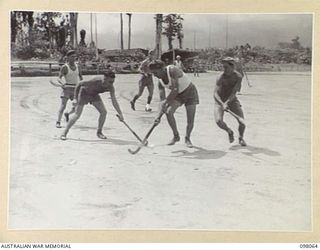 TOROKINA, BOUGAINVILLE, 1945-10-15. THE 11 FIELD AMBULANCE HOCKEY TEAM STRONGLY ATTACKING ON THE HEADQUARTERS 2 CORPS GOAL LINE DURING THE BOUGAINVILLE ASSOCIATION HOCKEY FINAL AT TURTON OVAL