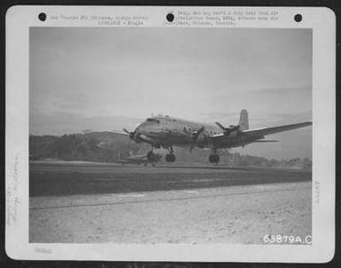 A C-54 Douglas 'Skymaster' Comes In From Guam On Yonta Airstrip, After Six Hour Flight. These Planes Of The Nats (Naval Air Transport Service) Carried High Priority Personnel, Medical Equipment And Supplies. On The Return Trip To Guam They Carried Wound (U.S. Air Force Number 63879AC)