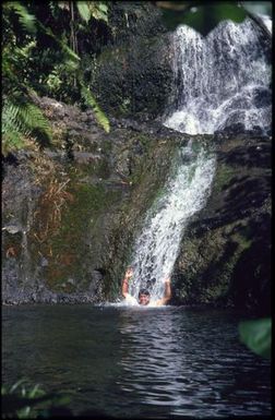 Woman in waterfall, Rarotonga