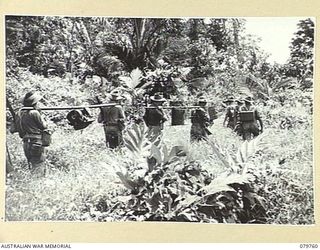 AITAPE, NEW GUINEA. 1945-03-16. MEMBERS FROM HEADQUARTERS 6TH DIVISION SIGNALS. IN JUNGLE COUNTRY SHOWING STATION ON MOVE WITH THE FOLLOWING:- SET; POWER SUPPLY AND TWO BATTERIES; CHARGER AND ..