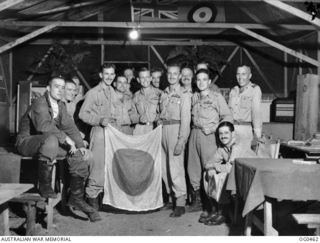 KIRIWINA, TROBRIAND ISLANDS, PAPUA. 1944-01-11. RETRIEVED FROM A JAPANESE BOMBER AIRCRAFT SHOT DOWN BY A SPITFIRE AIRCRAFT, THIS FLAG IS NOW HUNG IN THE MESS OF NO. 79 (SPITFIRE) SQUADRON RAAF ON ..