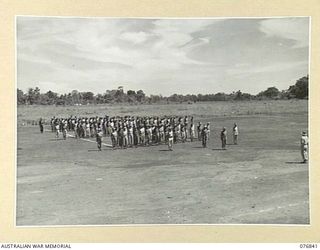 LAE, NEW GUINEA. 1944-11-11. OFFICERS, STAFF AND PATIENTS OF THE 112TH CONVALESCENT DEPOT ON THE UNIT PARADE GROUND FOR THEIR WEEKLY PARADE