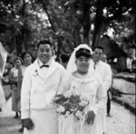 Bride and groom strolling the village path