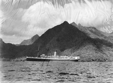 [Large ship by mountainous coastline]