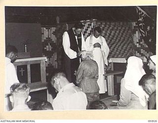 TOROKINA, BOUGAINVILLE, 1945-07-12. CHAPLAIN GENERAL C.L. RILEY, CHURCH OF ENGLAND (1), OFFICIATING AT THE CONFIRMATION SERVICE IN THE NEW CHAPEL AT HEADQUARTERS 2 CORPS. FIFTY-THREE MEMBERS WERE ..