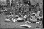 Mortuary ceremony, Omarakana: women with banana leaf bundles and piles of yams for ritual exchange