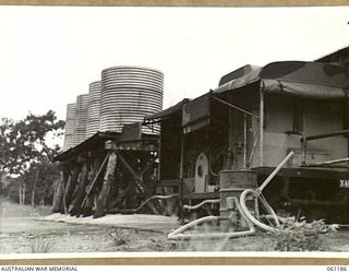 17 MILE, PORT MORESBY AREA, NEW GUINEA. 1943-12-04. WATER HEATING UNIT AND WATER STORAGE TANKS AT THE 9TH AUSTRALIAN DIVISION MOBILE LAUNDRY