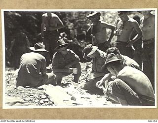 MOUNT PROTHERO, NEW GUINEA. 1944-01-2O. THE MAIL OF THE 2/12TH INFANTRY BATTALION BEING SORTED AND DISTRIBUTED IN THE FORWARD AREAS. IDENTIFIED PERSONNEL ARE:- SERGEANT FITZPATRICK, HEADQUARTERS ..