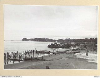 AITAPE, NEW GUINEA. 1945-04-19. SUPPLIES BEING UNLOADED FROM BARGES AT THE BEACH HEAD
