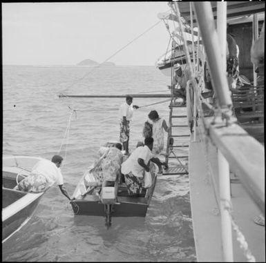 Passengers disembarking from a ferry into a dinghy, near Vanua Levu, Fiji, 1966 / Michael Terry