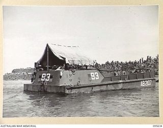 JACQUINOT BAY, NEW BRITAIN. 1945-08-31. AUSTRALIAN LANDING CRAFT 40 (AB2107), OF 53 PORT CRAFT COMPANY ROYAL AUSTRALIAN ENGINEERS. THE VESSEL IS IN THE PORT CRAFT AREA AND TENTS ARE ERECTED ON TOP ..