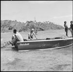 Young Fijian boys helping to anchor a motorboat on a beach, Vanua Levu, Fiji, November 1966 / Michael Terry