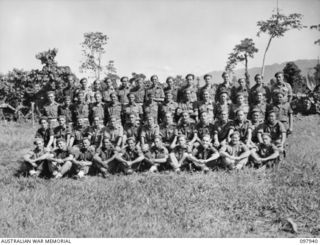 Torokina, Bougainville. 1945-10-12. Group portrait of the members of E Troop, 6th Battery, 2nd Field Regiment in their unit lines. Left to right, back row: VX87712 Sergeant (Sgt) R. M. Browne of ..