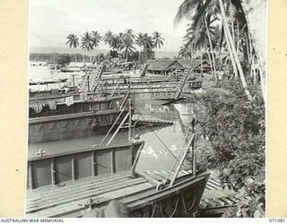 LABU, NEW GUINEA. 1944-03-10. A MIXTURE OF VESSELS UNDER REPAIR AT THE 1ST WATERCRAFT WORKSHOP, AUSTRALIAN ELECTRICAL AND MECHANICAL ENGINEERS. THE WORKSHOPS ARE KEPT BUSY REPAIRING LANDING CRAFT, ..