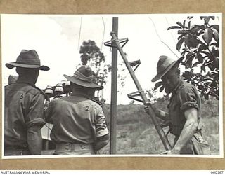 SOGERI, NEW GUINEA. 1943-11-20. STUDENTS OF THE SCHOOL OF SIGNALS, NEW GUINEA FORCE BUILDING UP A MULTI-AIRLINE ROUTE DURING A TRAINING EXERCISE. THEY ARE: NX66084 SIGNALMAN A. J. HILL, 19TH LINES ..