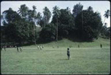 Boys playing football in a field