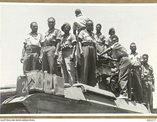 SOUTHPORT, QLD. 1944-01-18. NEW GUINEA NATIVE POLICE BOYS INSPECTING A MATILDA TANK AT THE 4TH ARMOURED BRIGADE HEADQUARTERS