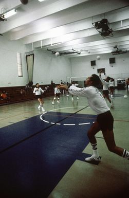 John Windmiller of Randolph Air Force base, Texas, warms up with other members of the Air Force team, before a game at the Interservice Volleyball Competition