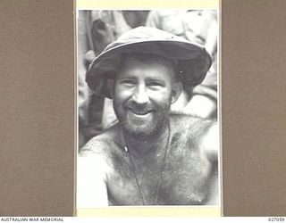 PAPUA, NEW GUINEA. 1942-10. CORPORAL A. MCKEOWN, 2/31ST AUSTRALIAN INFANTRY BATTALION, PHOTOGRAPHED ON THE TRACK BETWEEN NAURO AND MENARI IN THE OWEN STANLEY RANGES. HE HAD NOT SHAVED FOR A MONTH