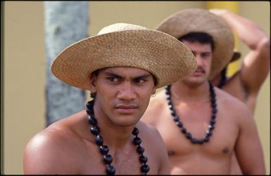 Young men wearing straw hats and necklaces