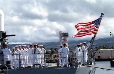 Crewmen stand at parade rest as the casket of the Unknown Serviceman of the Vietnam Era is carried aboard the frigate USS BREWTON (FF 1086), at the conclusion of a wreath-laying ceremony. The casket will be transported to California and then transferred to Arlington National Cemetery for interment at the Tomb of the Unknowns