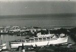 Port of Papeete with a liner. Behind, the French Navy's naval bases