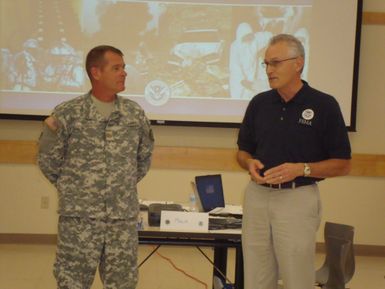 American Samoa, Dec. 8, 2010 -- Farley Howell, FEMA Region IX Federal Preparedness Coordinator, recognizing Major Taylor of the U.S. Army Reserve Unit in American Samoa for his support of the Training, Exercise and Planning Workshop