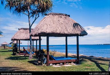 Fiji - beachside recliner underneath bure-style thatched roof, Denaru Island Resort