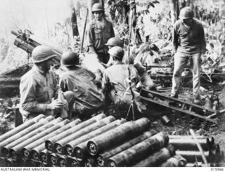 1943-08-16. NEW GUINEA. MOUNT TAMBU. ONE OF THE GUNS OF AN AMERICAN BATTERY IN NEW GUINEA, FIRING AT TARGETS ON MOUNT TAMBU AND THE KOMIATUM TRACK. THESE GUNS WERE CARRIED IN PARTS OF 100 TO 250 ..