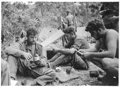 Mail and meal time at Parers Bowl, Orodubi, New Guinea, 28 July, 1943
