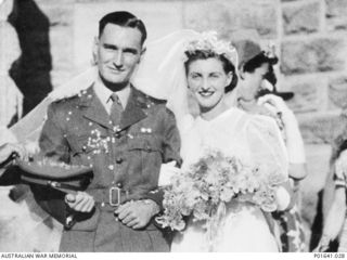 WX3093 Captain (Capt) Ronald Henry Christian MC and bar and his bride the former Yvonne Marcelline Marie 'Dickie' Antoine outside the church after their wedding. The then Corporal Christian and ..