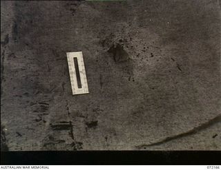 Fortification Point, New Guinea. 1944-04-08. A sisal craft paper splinter sheet showing the piercing effect of a round against the frontal armour of a disabled Australian Matilda tank. The round ..