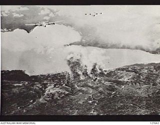 LAE, NEW GUINEA. 1944-04. LIBERATORS OF UNITED STATES ARMY AIR FORCE 90TH BOMB GROUP ATTACKING THE TOWNSHIP