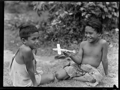 Two unidentified local boys with model aeroplane, Rarotonga, Cook Islands