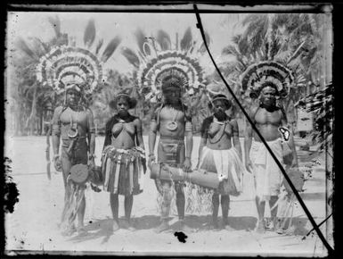 Five Papuan dancers, three men with hand drums and two women, Papua, ca. 1923 / Sarah Chinnery