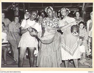 LAE, NEW GUINEA. 1945-11-08. THE DARKIES GROUP, COMPRISING PRIVATE J. SMITH (1); PRIVATE M.B. MALONEY (2); AND CORPORAL D.M. O'CONNELL (3). THEY WERE JUDGED THE BEST GROUP AT THE FANCY DRESS PARTY ..